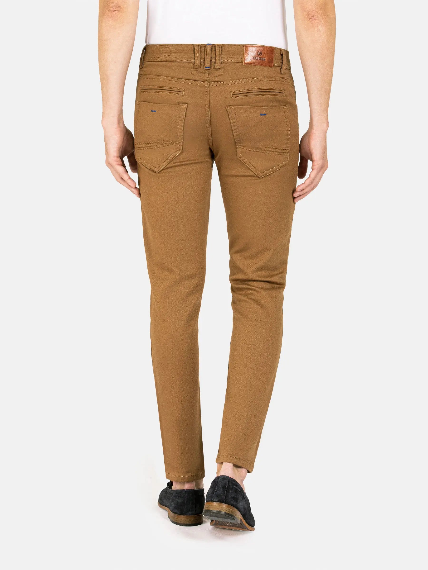 Back view of slim-fit camel brown jeans with stitched pockets and leather label – Wam Denim.