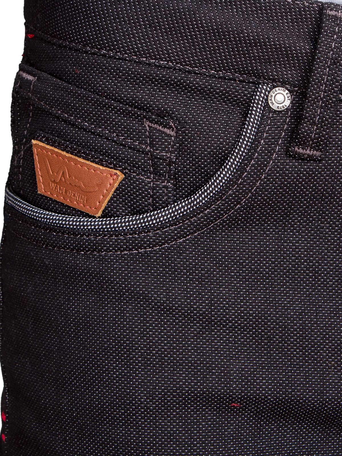 Close-up of black denim jeans front pocket with contrast stitching and leather Wam Denim tag – Wam Denim.