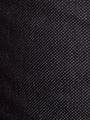Close-up of black textured denim fabric with fine dotted weave pattern – Wam Denim.
