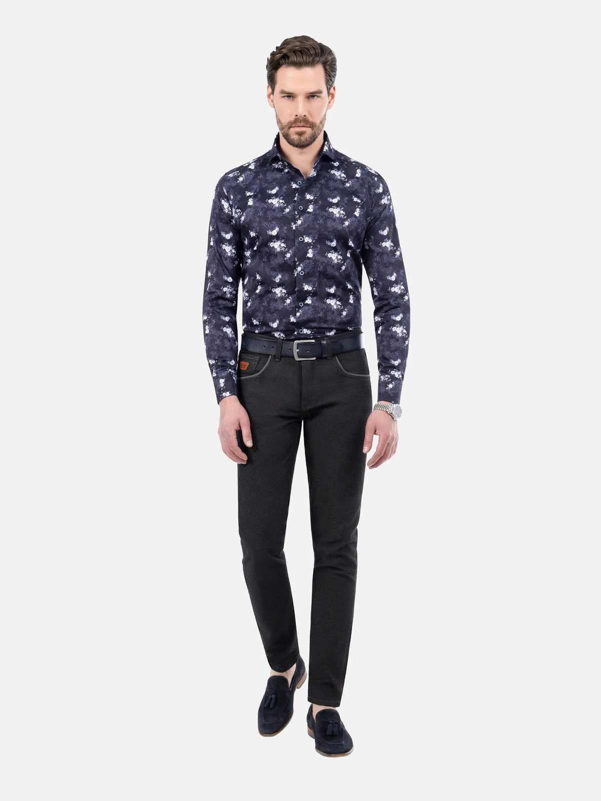 Man wearing slim-fit black patterned jeans with navy floral shirt and loafers – Wam Denim.