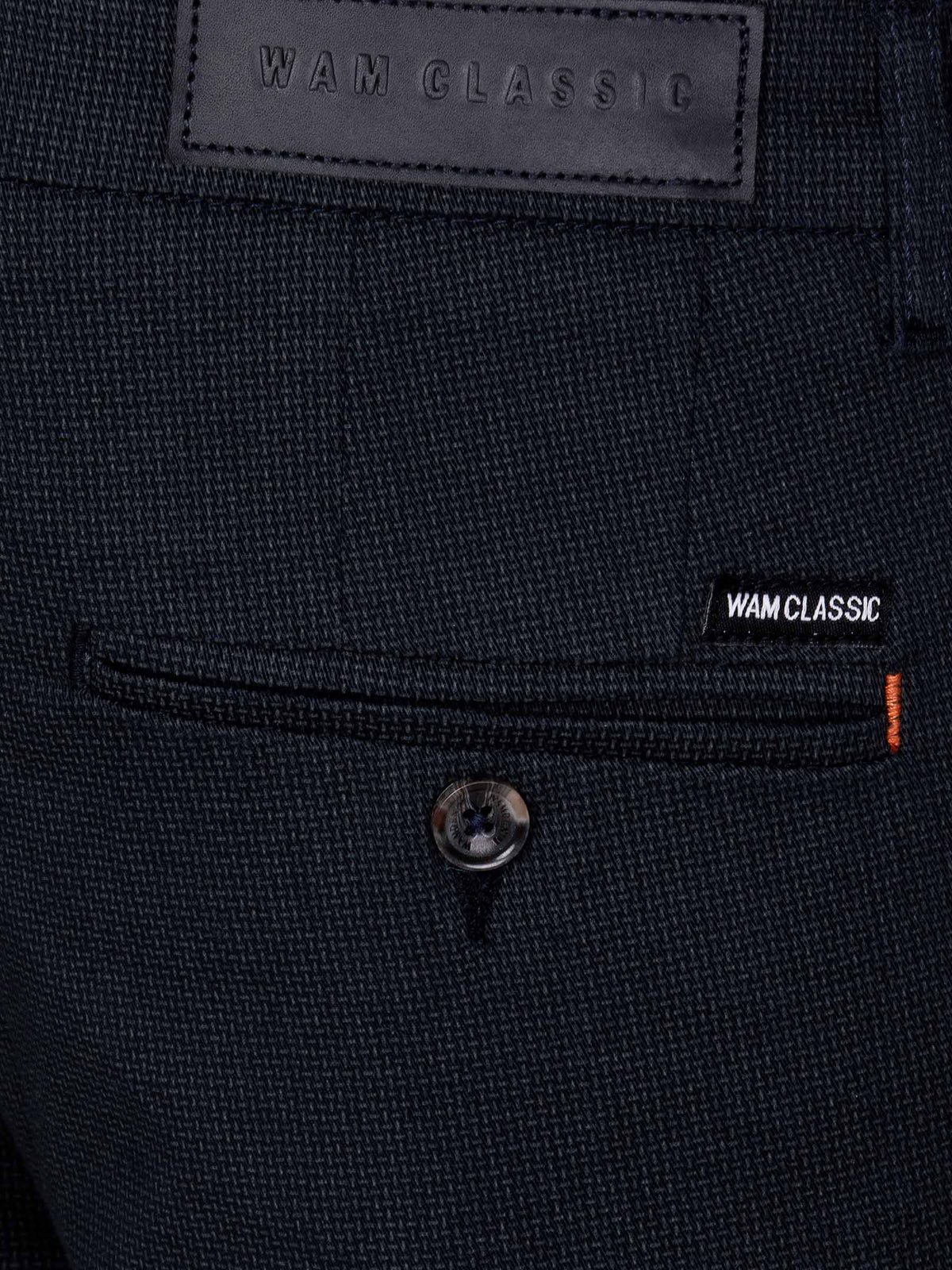 Close-up of navy textured chinos with Wam Classic label and buttoned back pocket – Wam Denim.