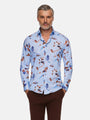 Man wearing a light blue floral print shirt paired with brown trousers – Wam Denim.