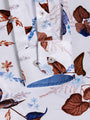 Close-up of floral shirt cuff with blue contrast inner lining and button detail – Wam Denim.