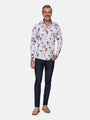 Full-body view of man wearing white floral long-sleeve shirt with dark jeans – Wam Denim.