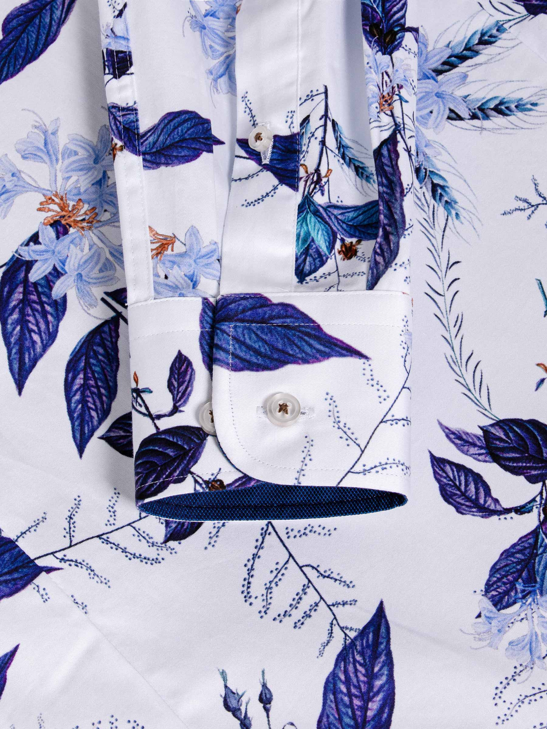Close-up of blue floral print shirt cuff with button and fine stitching detail – Wam Denim.