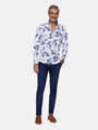 Man wearing white and blue floral print shirt paired with navy trousers and brown loafers – Wam Denim.