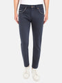 Man wearing dark blue slim-fit jeans with white sneakers. – Wam Denim.