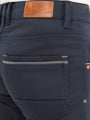 Close-up of dark blue jeans with leather label and pocket. – Wam Denim.
