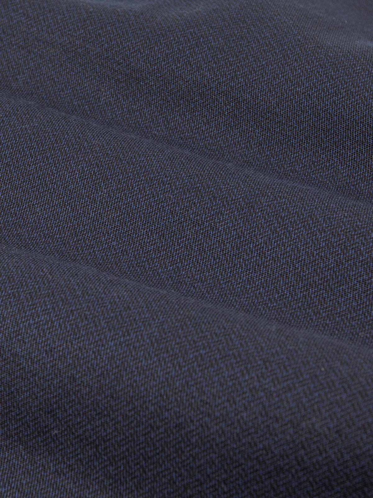 Close-up of dark blue denim fabric with textured weave. – Wam Denim.