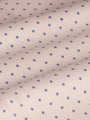 Close-up of beige fabric with purple dot pattern, textured. – Wam Denim.