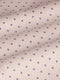 Close-up of beige fabric with purple dot pattern, textured. – Wam Denim.