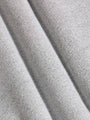 Close-up of textured gray fabric with folds