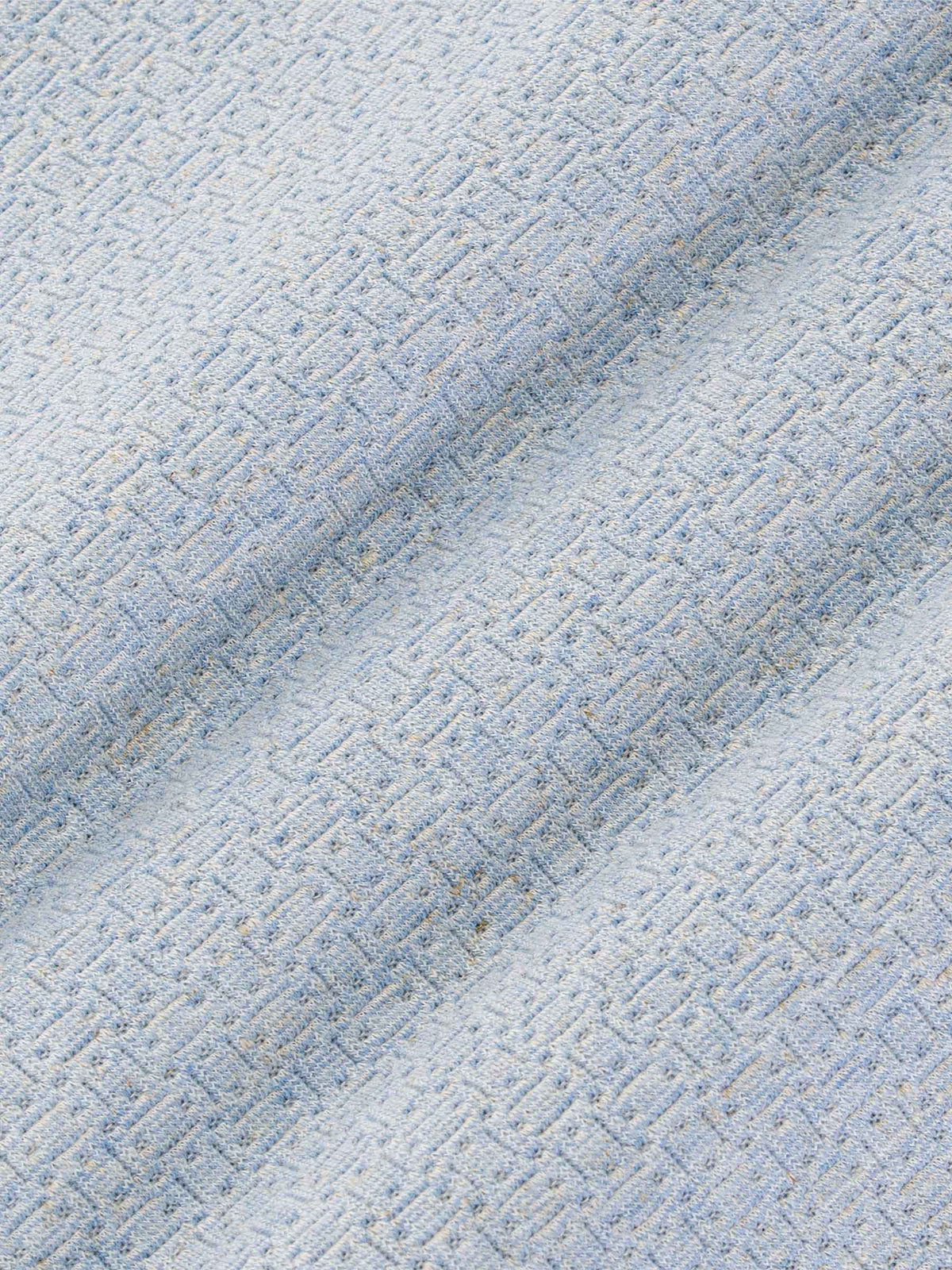 Close-up texture of blue fabric with a geometric pattern – Wam Denim.