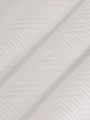 Close-up of the textured white fabric with a geometric pattern – Wam Denim.