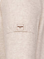 Close-up of a beige garment with a 'WAM Denim Italy' label on a pocket.