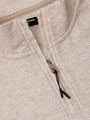 Close-up of a beige fleece sweater with a zipper and ' Wam Denim' brand label.