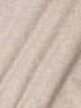 Close-up of beige fabric with a textured pattern