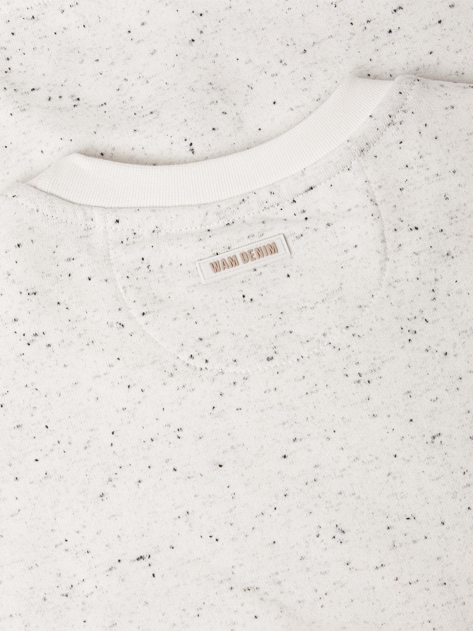 Speckled white sweater with a brand label on a white background
