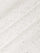 Close-up of a textured white surface with small black specks