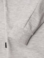 Close-up of light grey sweatshirt sleeve with ribbed cuff and woven label – Wam Denim.