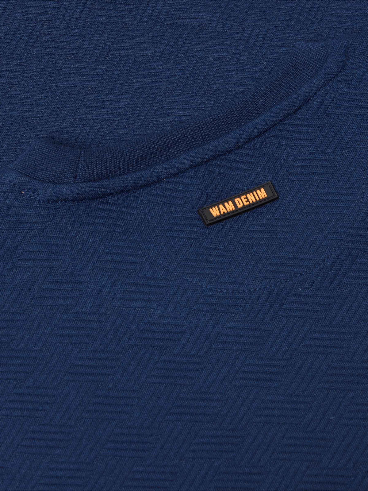 Close-up of navy Moorland Sweater with brand tag. – Wam Denim.