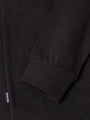 Close-up of black sweater sleeve with ribbed cuff and woven texture detail – Wam Denim.