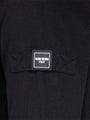 Close-up of sleeve patch with Wam Denim Italy logo on black textured sweater – Wam Denim.