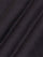 Close-up of black textured knit fabric showcasing fine weave and smooth finish – Wam Denim.