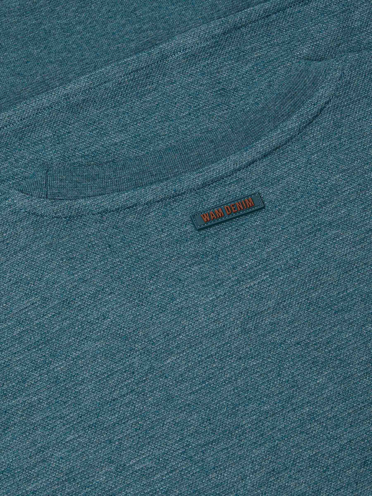 Close-up of back neck area with subtle Wam Denim logo tag on petrol fabric – Wam Denim.