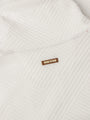 Close-up of white textured sweatshirt fabric with stitched Wam Denim logo patch – Wam Denim.