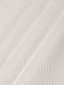 Close-up of white sweatshirt fabric featuring soft geometric textured pattern – Wam Denim.