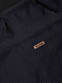 Close-up of chest logo and drawstring detail on black textured sweater – Wam Denim.