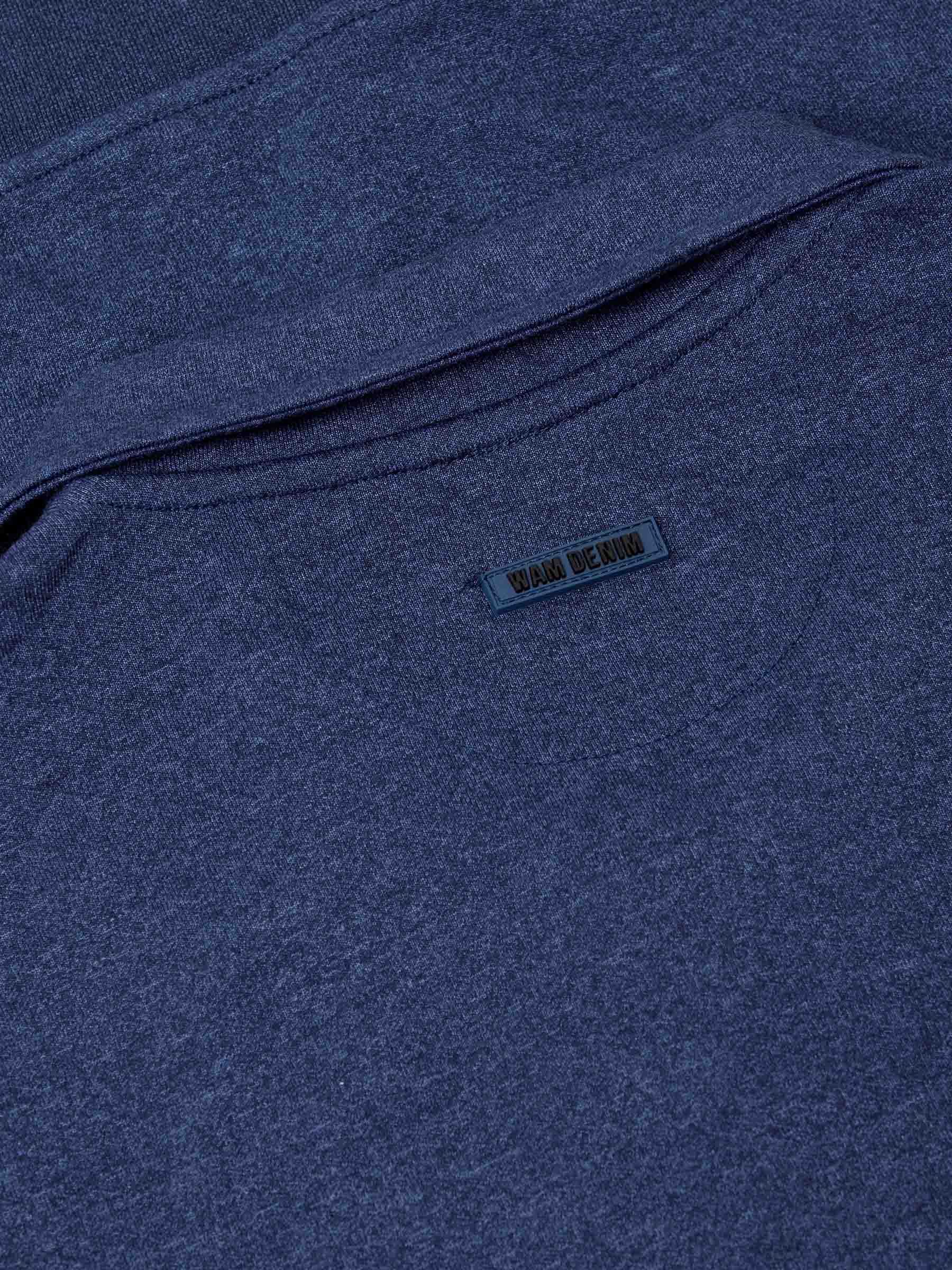 Back collar close-up with embossed Wam Denim logo on light indigo fabric – Wam Denim.