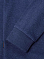 Close-up of ribbed cuff and hem detailing on light indigo sweater fabric – Wam Denim.