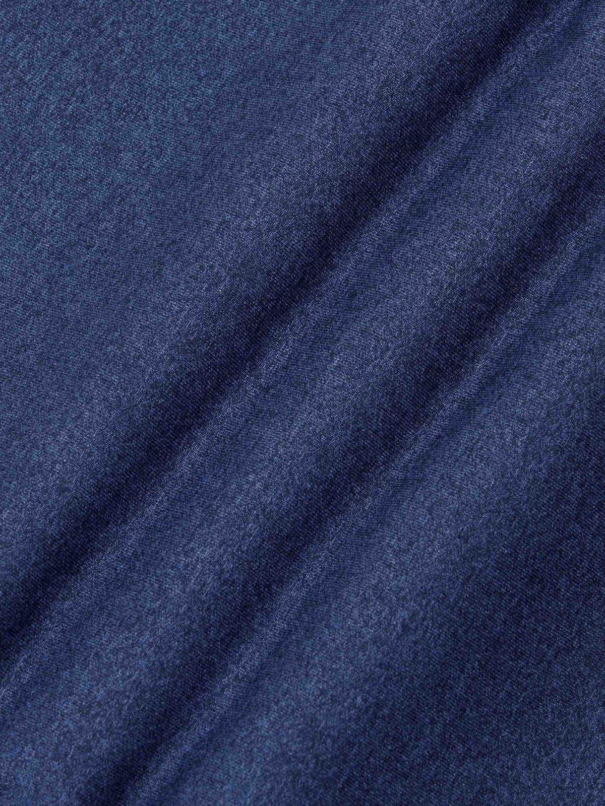 Close-up texture of light indigo knit fabric showing soft and smooth weave – Wam Denim.
