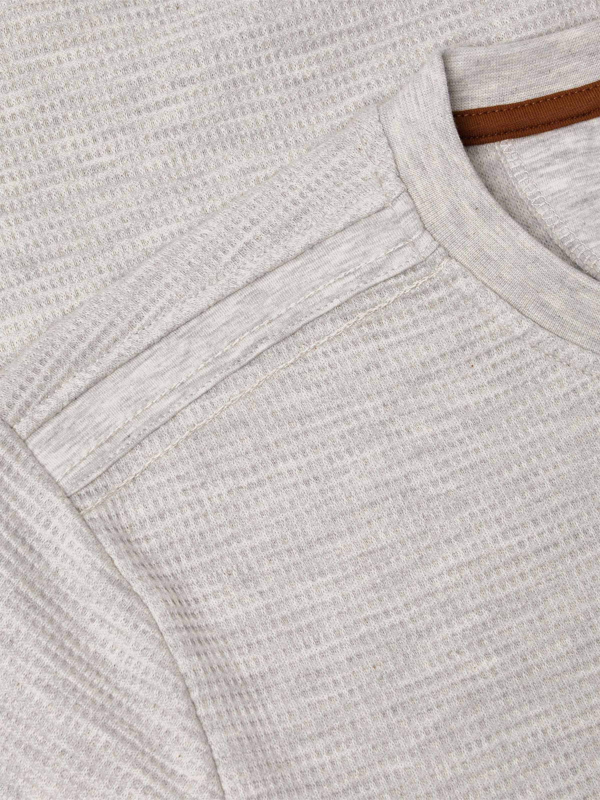 Close-up of light grey sweatshirt shoulder and neckline stitching with textured fabric – Wam Denim.