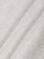 Close-up of soft light grey waffle-textured fabric showing fine knit details – Wam Denim.