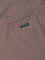 Close-up of the Wam Denim label on the textured sweater – Wam Denim.