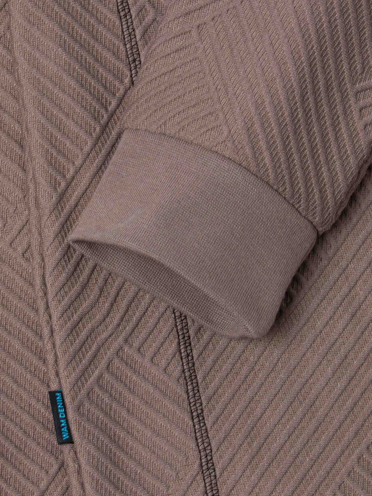 Close-up of the ribbed cuff and knit fabric on the sweater – Wam Denim.