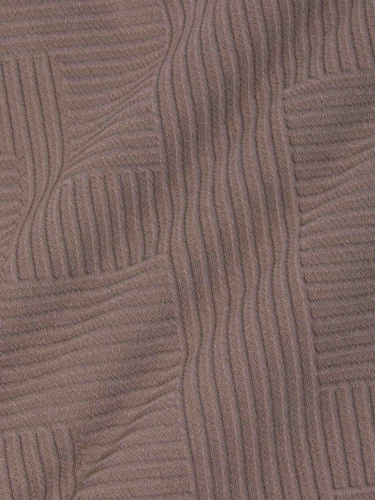 Close-up texture of knit fabric with geometric pattern – Wam Denim.