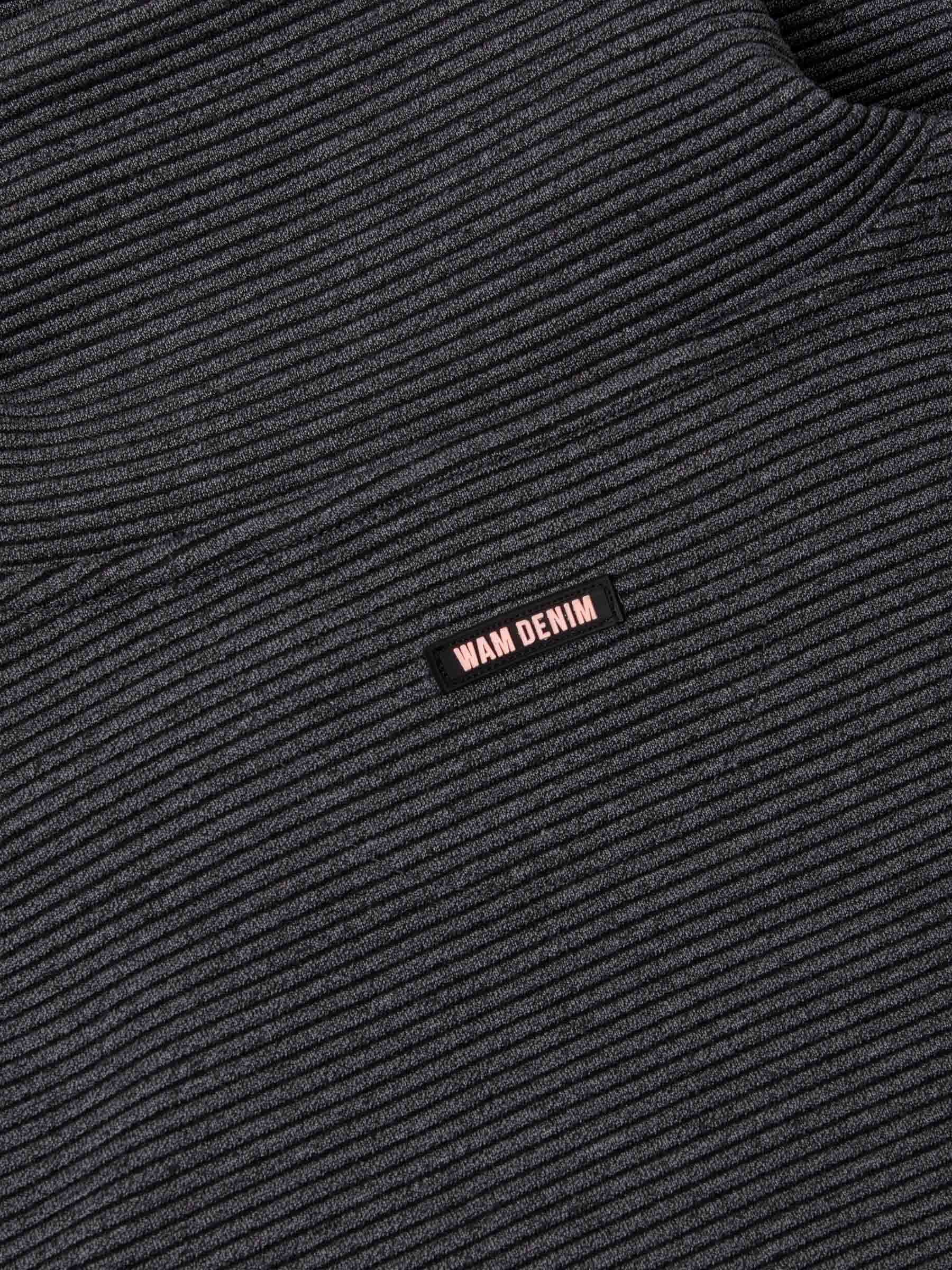 Close-up of ribbed Anthracite fabric featuring a small woven Wam Denim logo tag – Wam Denim.