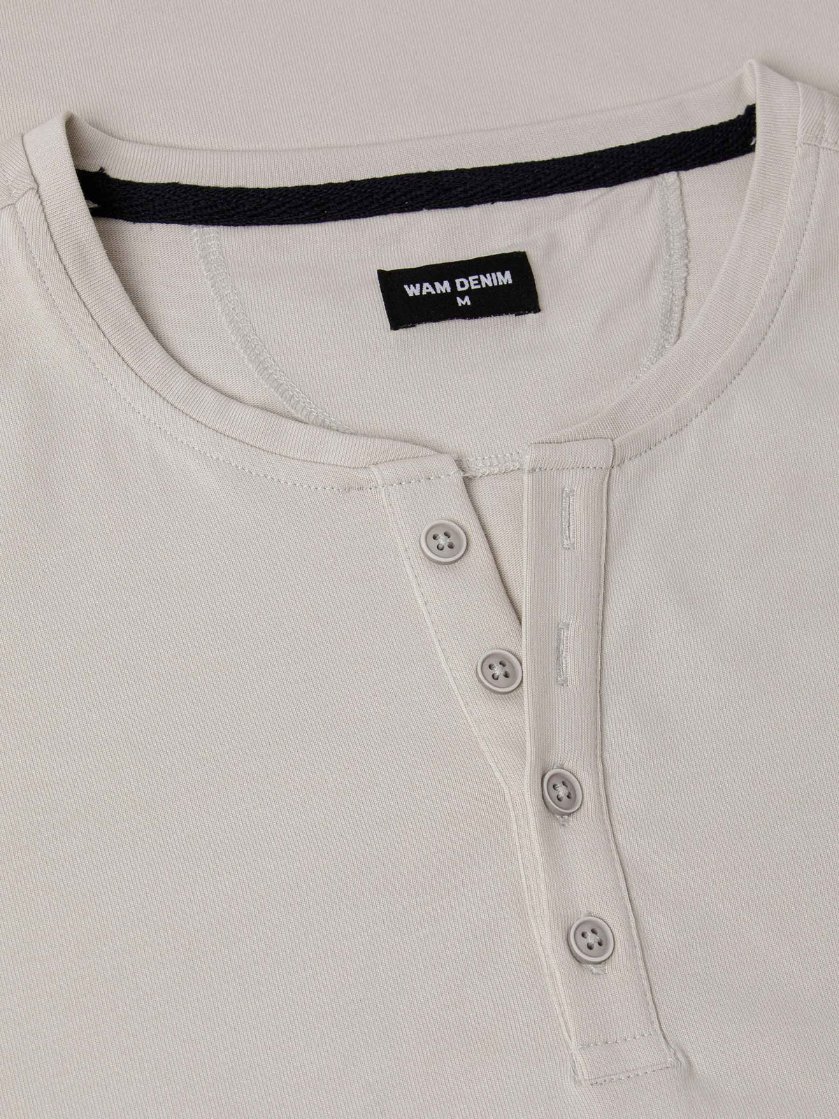Close-up of The Fervor Light Beige Sweater neckline with button placket and Wam Denim label – Wam Denim.