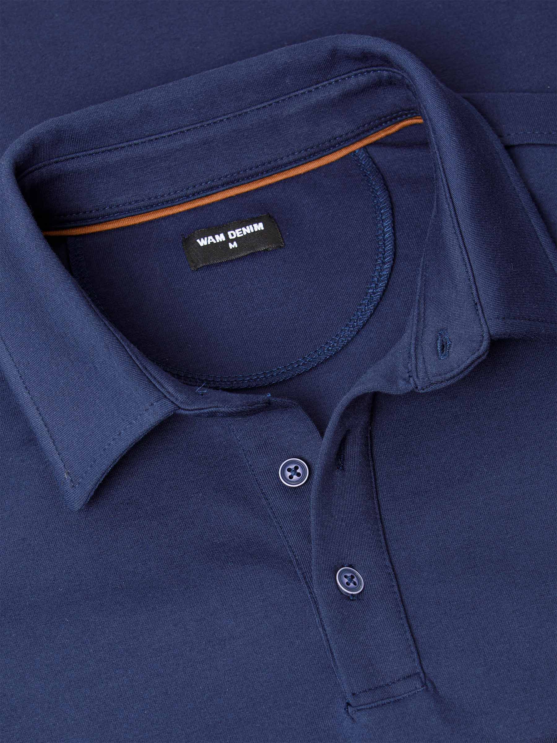 Close-up of a Navy Sweater with a brand label on the collar.