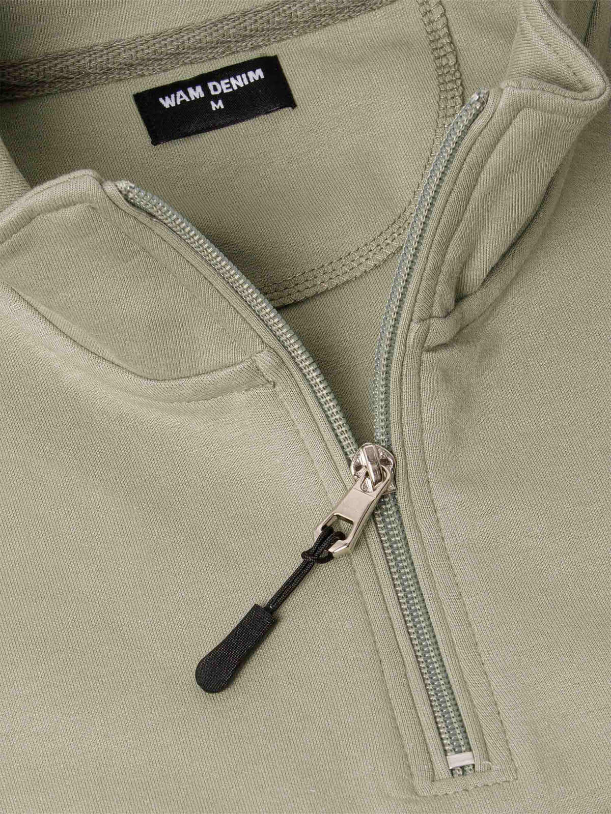 Close-up of a Light Green Sweater with a zipper and 'WAM Denim' label.