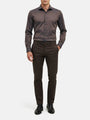 Men wearing light brown slim-fit shirt styled with dark trousers and dress shoes.