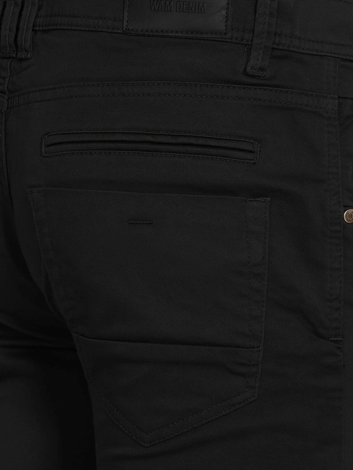 Close-up of black jeans showing detailed stitching and rear pocket design.
