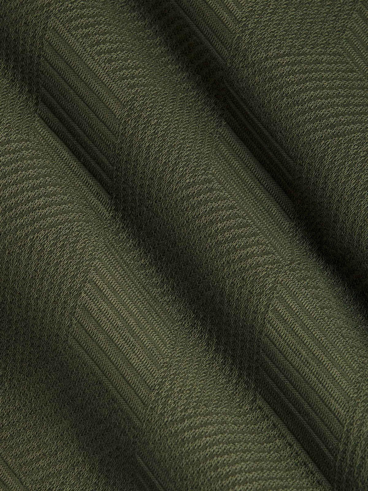Close-up of khaki textured fabric with geometric pattern detail