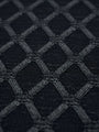 Close-up of anthracite knit sweater fabric featuring a raised geometric diamond pattern.