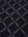 Close-up of anthracite knit sweater fabric featuring a raised geometric diamond pattern.