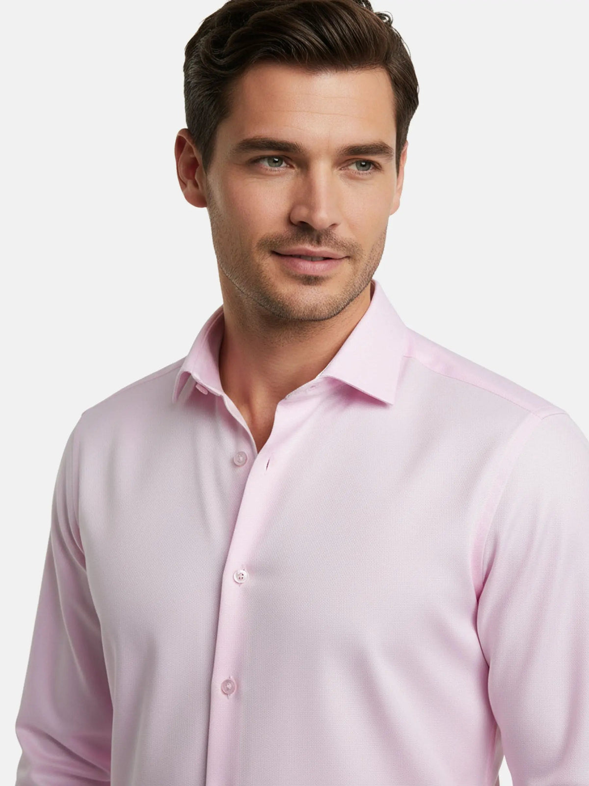 Model wearing pink dress shirt with classic collar, close-up view.